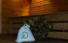 Парная в бане с деревянными полками и банными вениками